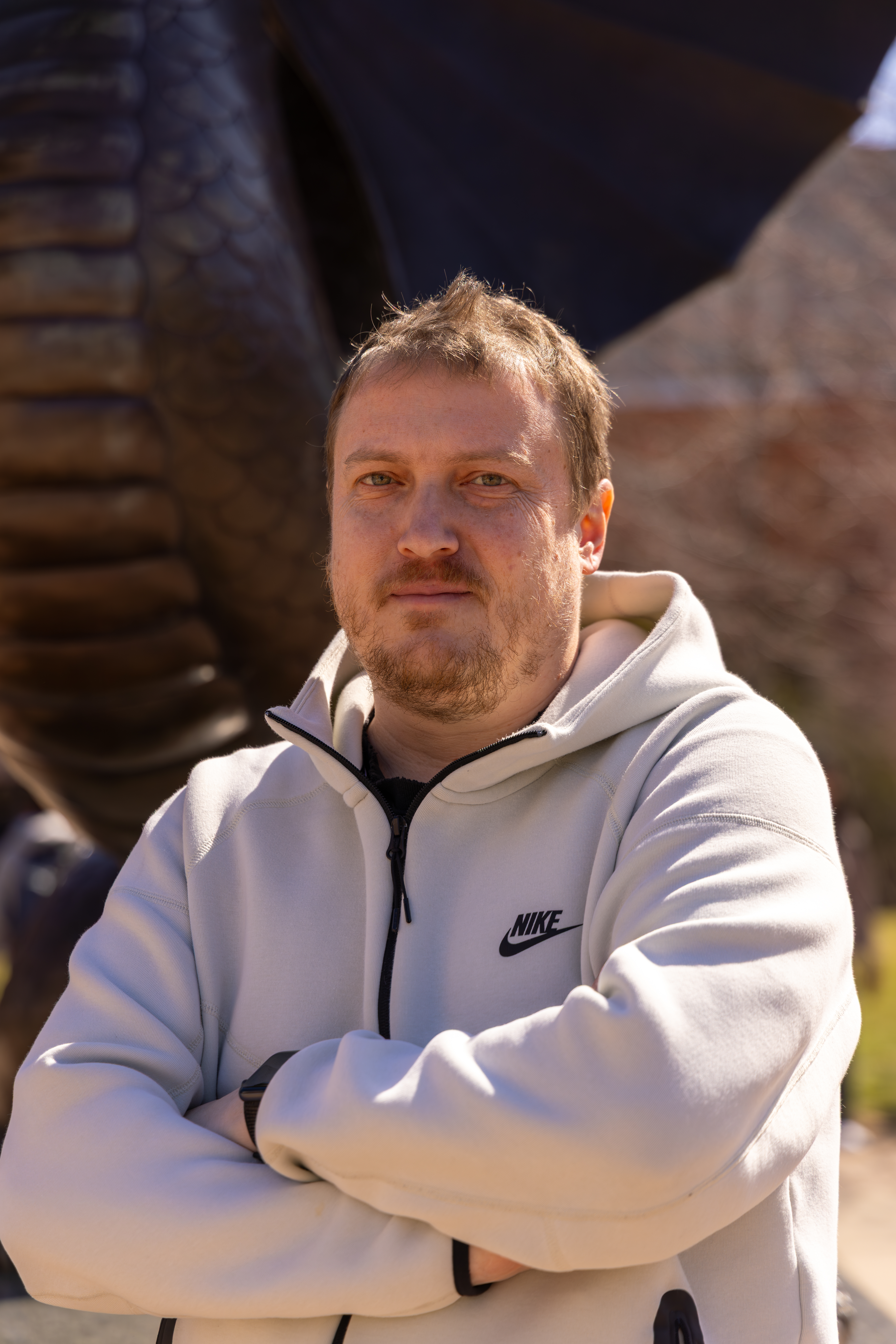headshot of man in hoodie outside